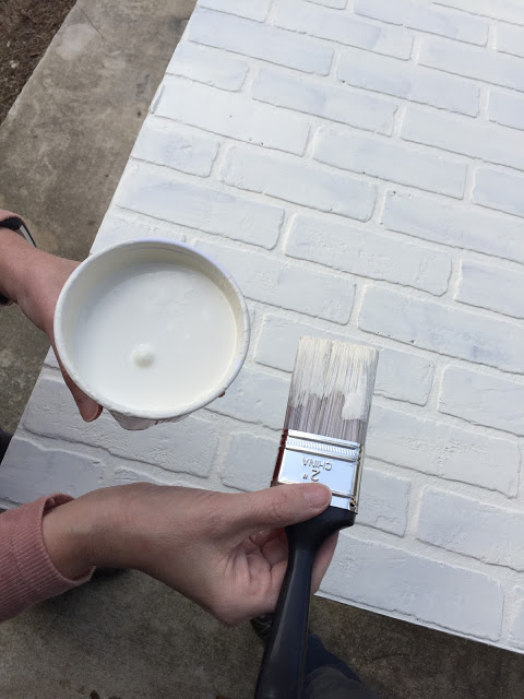 faux brick wallboard painted white for a kitchen backsplash