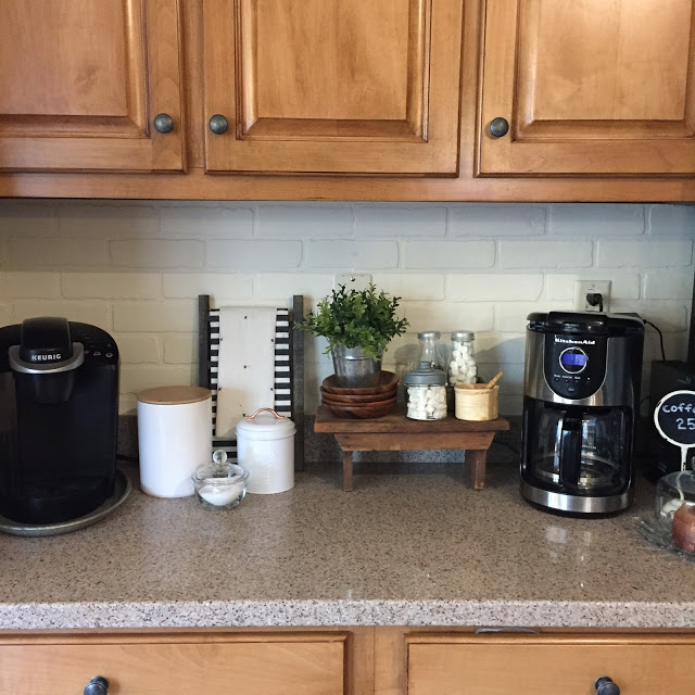 DIY painted faux brick backsplash in a cottage kitchen