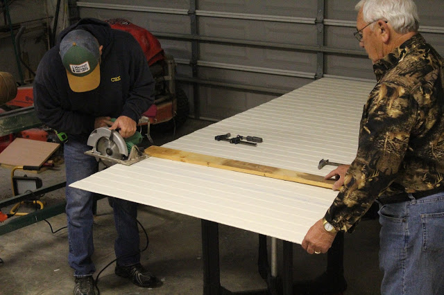 Cutting the painted faux brick wallboard for a DIY kitchen backsplash