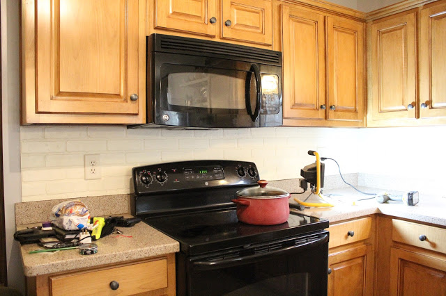 using faux brick wall board for a kitchen backsplash