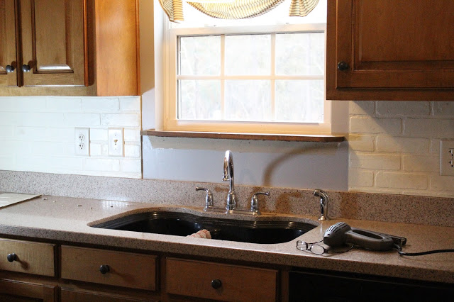 using faux brick wall board for a kitchen backsplash