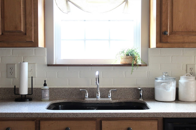 DIY painted faux brick backsplash in a cottage kitchen