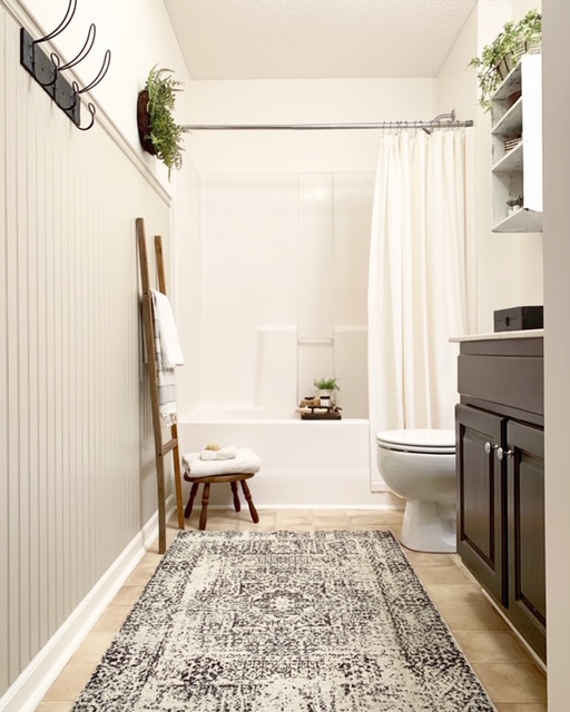 A cottage style bathroom with bead board wall treatment