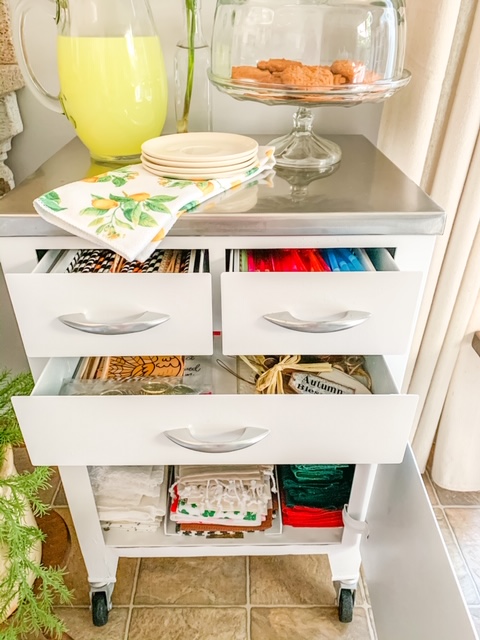 a vintage medical cabinet used for storing entertaining supplies