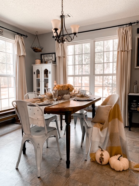 a neutral fall table setting in a cozy kitchen