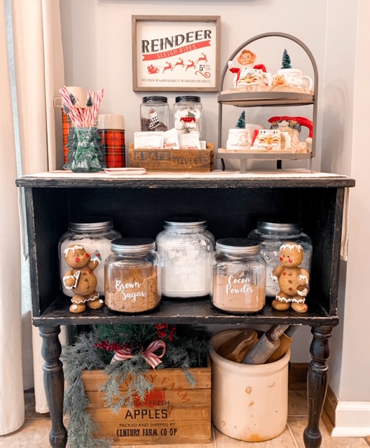 Christmas hot cocoa bar decorated with vintage santa mugs