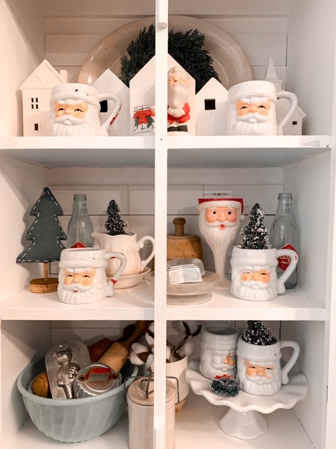 vintage Santa collection in pie safe