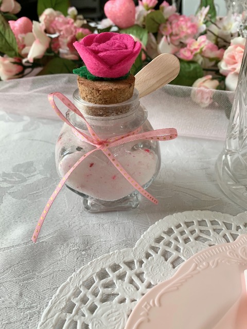 Heart shaped jar holding homemade sugar scrub as a Galentine's Day gift