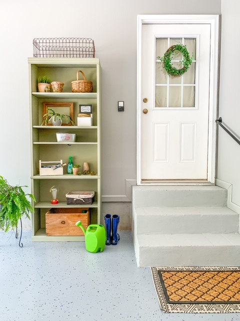 A garage entry makeover with a gardening shelf station