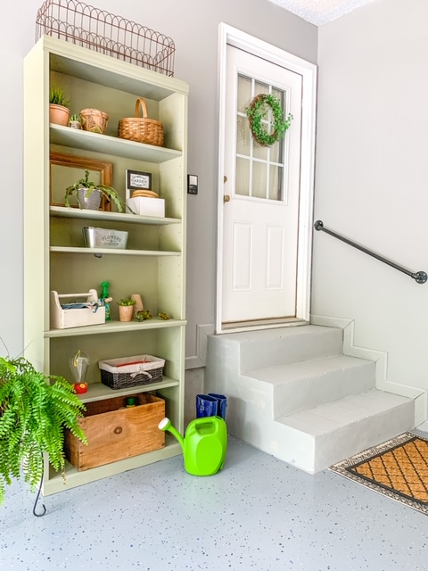 A garage entry makeover with a gardening shelf station