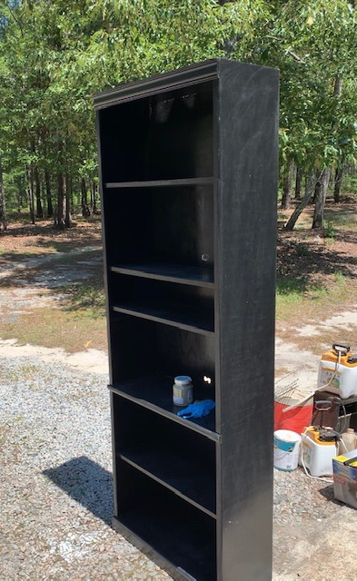 A before picture of an old book case repurposed for a gardening station