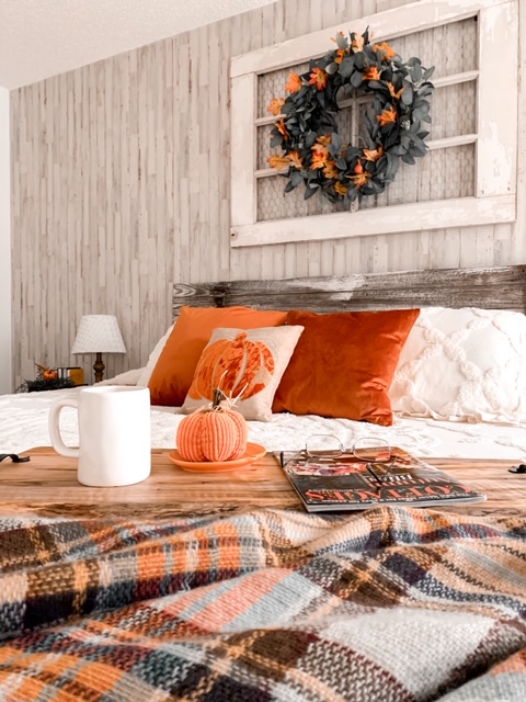 A cozy cottage bedroom styled with the colors of fall