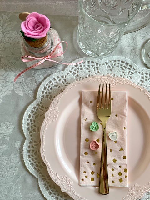 A pretty table place setting for a Galentine's Day brunch