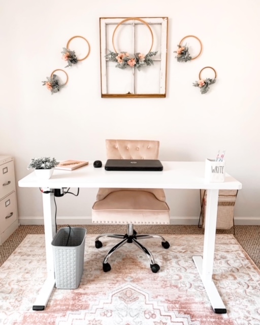 A cottage style home office featuring beautiful blush tones