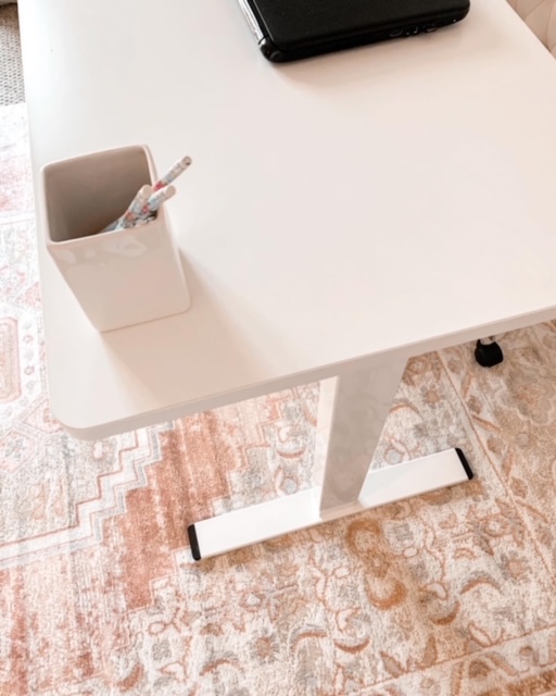 A white Flexispot Standing desk looks lovely in this cottage style home office