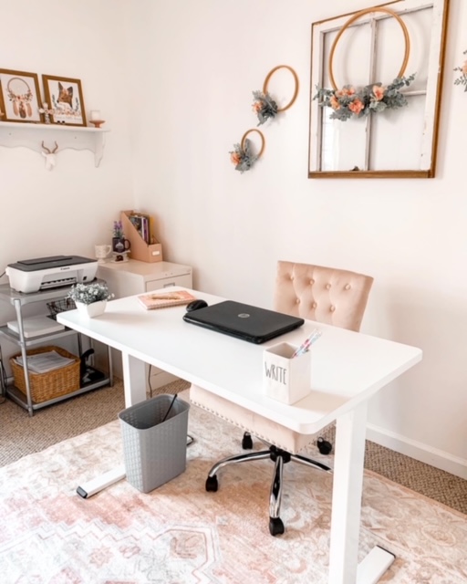 A cottage style home office decorated with blush tones