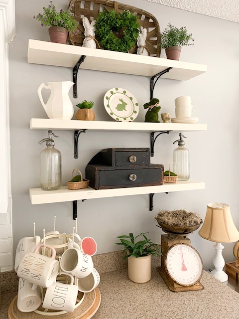 Kitchen open shelves styled for spring with bunnies and vintage finds