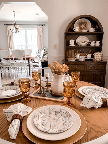 An early fall table scape is styled with amber glass and other thrifted finds