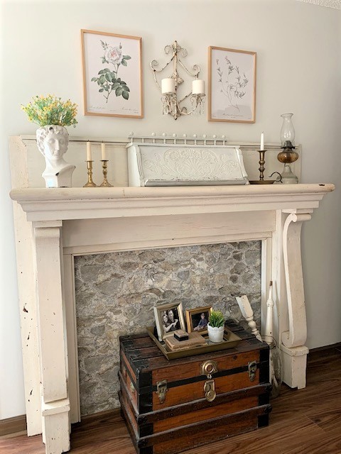 An antique mantel styled with vintage inspired home decor