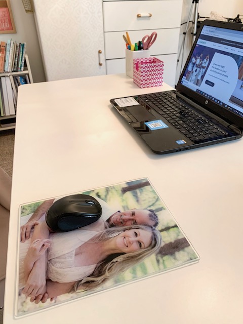 A glass mouse pad holds a favorite family photo