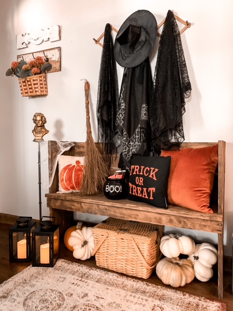 a front foyer styled for the fall season and Halloween with a place for the witch to park her broom and leave her hat and cape