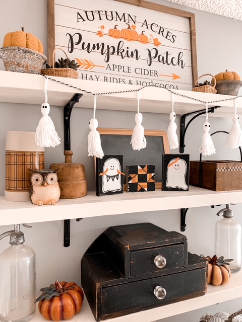 kitchen open shelves styled for Halloween with cute spooky decor and vintage finds