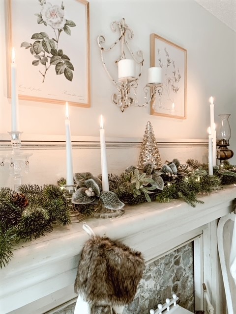 An antique chippy white bedroom mantle decorated in neutral Christmas decor