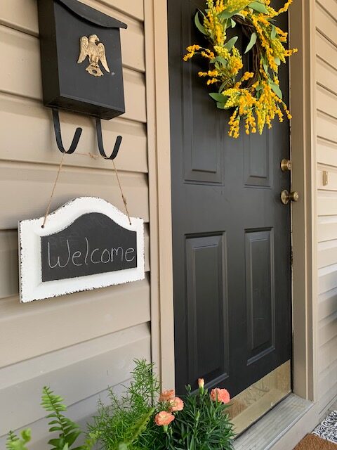 A bright yellow spring wreath says "Welcome" to your guests