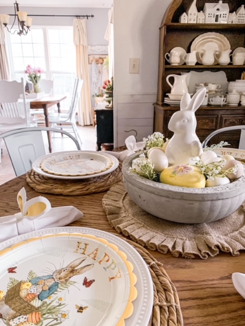 an Easter table centerpiece made with a diy concrete bowl, a bunny, and Easter eggs