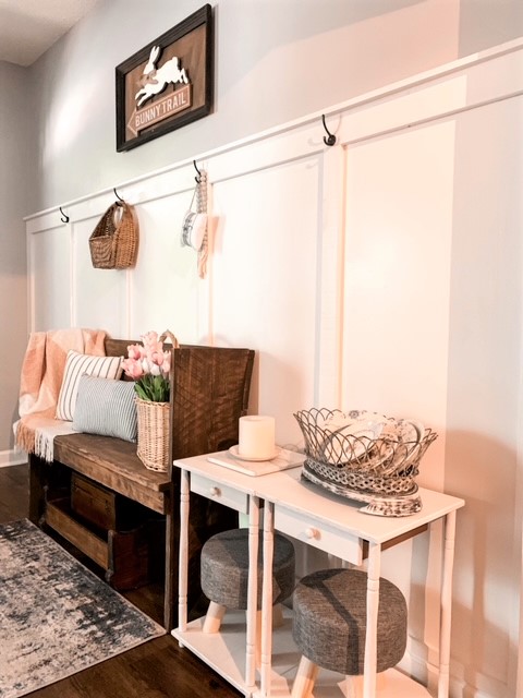 a cottage foyer styled for spring with a board and batten wall treatment