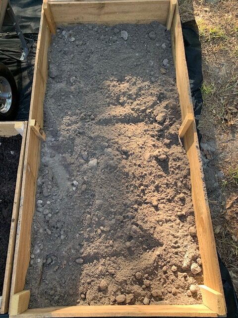 top soil in garden bed helps add filler