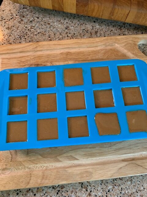 homemade dog treats poured into silicone candy mold