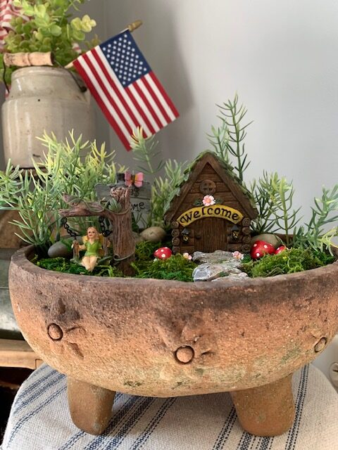 fairy garden in an aged terra cotta planter