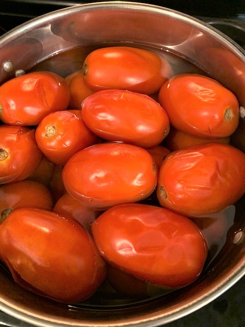 boil tomatoes to remove skins