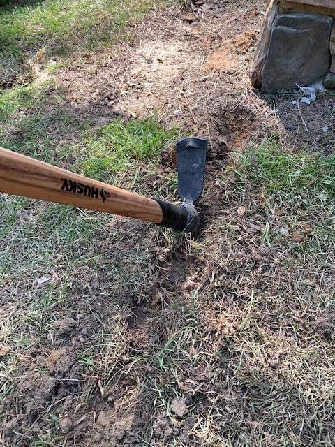 digging a trench by hand for patio