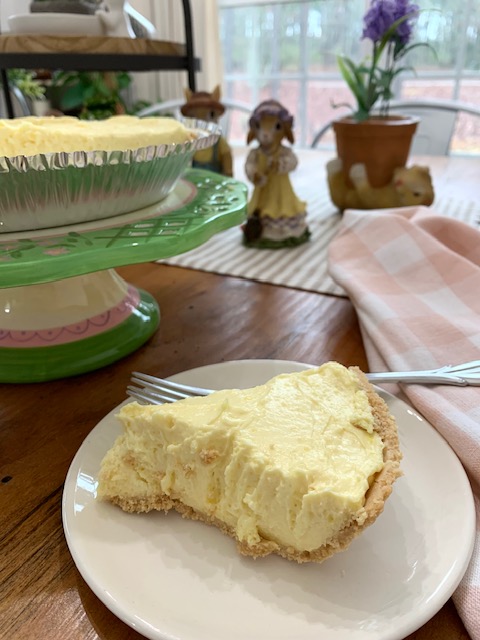 a slice of cream cheese lemon pie on a table for someone to enjoy