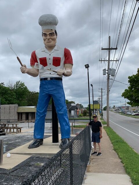 man standing next to a "giant" on Route 66
